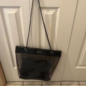 Clear purse with chain strap and makeup bag inside